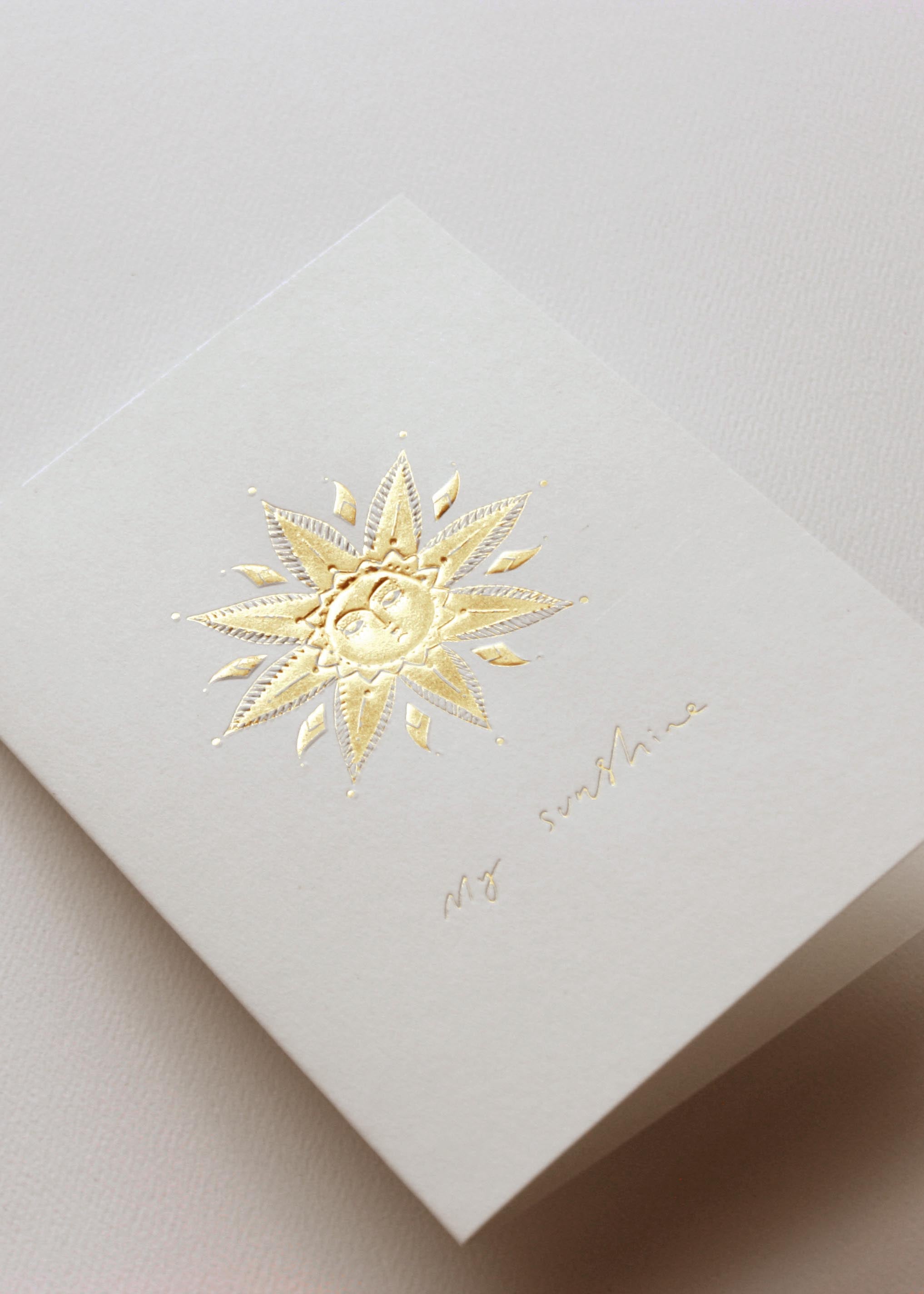 greeting cards diecut and hot foil printed with a sunshine, sunflower and hamsa design